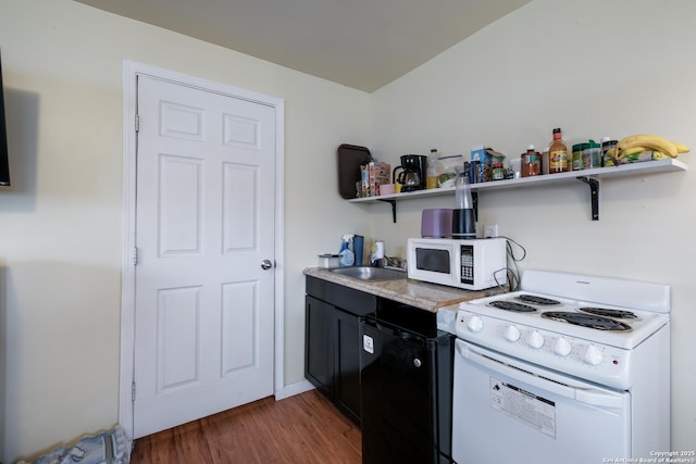 kitchen featuring white appliances, dark hardwood / wood-style flooring, and sink