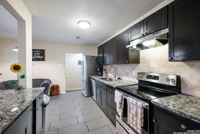 kitchen featuring stainless steel appliances, sink, and light stone counters