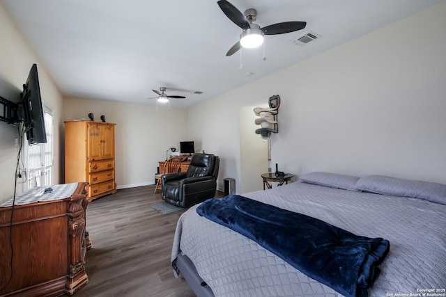 bedroom with dark hardwood / wood-style flooring and ceiling fan