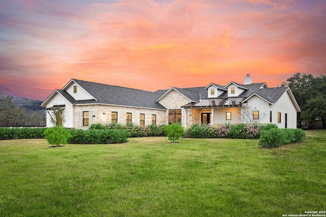 view of front of property with a lawn