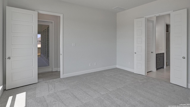 2929 Vistablue Ln, San Antonio, TX 78245 - unfurnished bedroom featuring ensuite bath, carpet floors, and baseboards