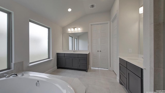 2929 Vistablue Ln, San Antonio, TX 78245 - bathroom featuring lofted ceiling, two vanities, visible vents, and a sink