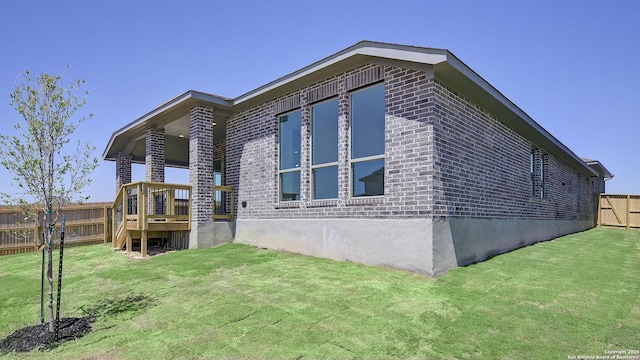 2929 Vistablue Ln, San Antonio, TX 78245 - view of property exterior featuring brick siding, fence, a wooden deck, and a yard