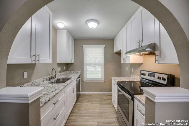 kitchen featuring sink, light hardwood / wood-style flooring, white cabinets, and appliances with stainless steel finishes