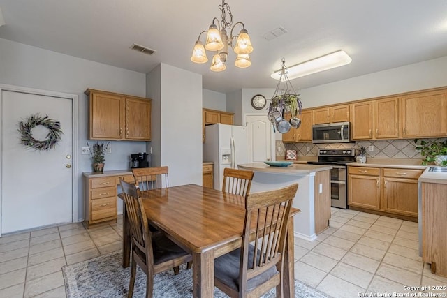 dining room with an inviting chandelier and light tile patterned floors