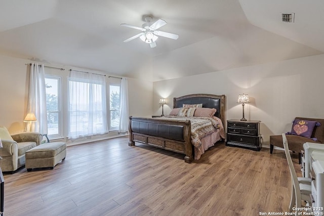 bedroom with vaulted ceiling, ceiling fan, and light hardwood / wood-style floors