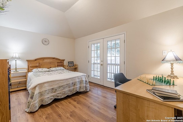 bedroom featuring french doors, lofted ceiling, light hardwood / wood-style flooring, and access to outside