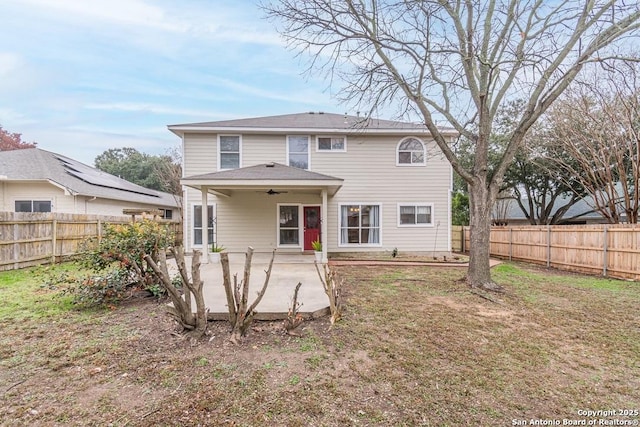 rear view of property featuring ceiling fan and a patio area