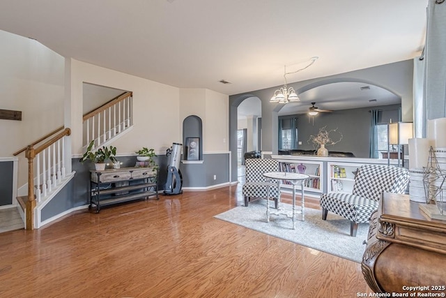 living room with ceiling fan and hardwood / wood-style floors