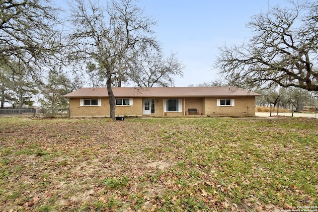 rear view of property featuring a yard