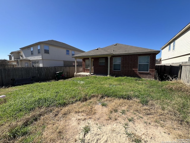 back of house with a lawn