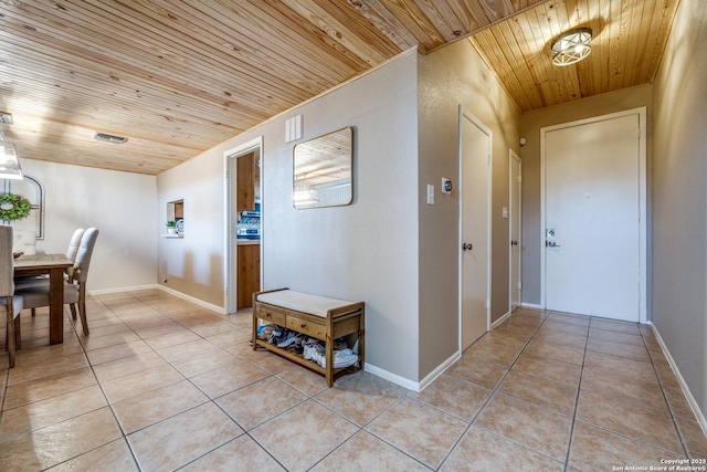 corridor featuring light tile patterned floors and wooden ceiling