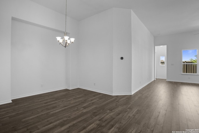 312 Hulda Trl, New Braunfels, TX 78130 - empty room with dark wood finished floors, a chandelier, and baseboards