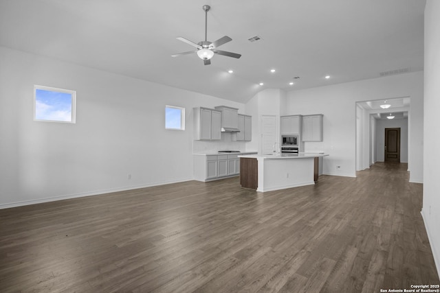 312 Hulda Trl, New Braunfels, TX 78130 - unfurnished living room featuring ceiling fan, recessed lighting, lofted ceiling, dark wood-style flooring, and baseboards