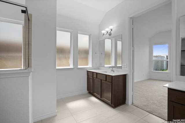 312 Hulda Trl, New Braunfels, TX 78130 - bathroom featuring vaulted ceiling, vanity, and baseboards