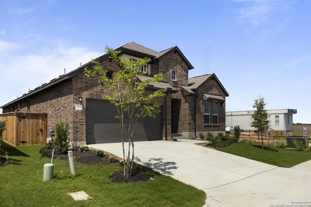 312 Hulda Trl, New Braunfels, TX 78130 - view of front of house featuring brick siding, concrete driveway, and a garage