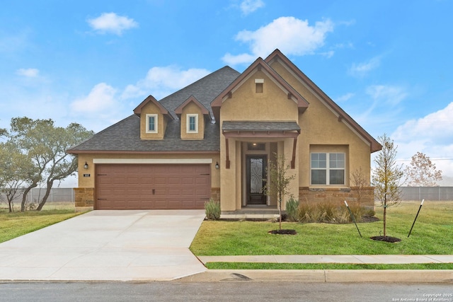 view of front facade with a garage and a front yard