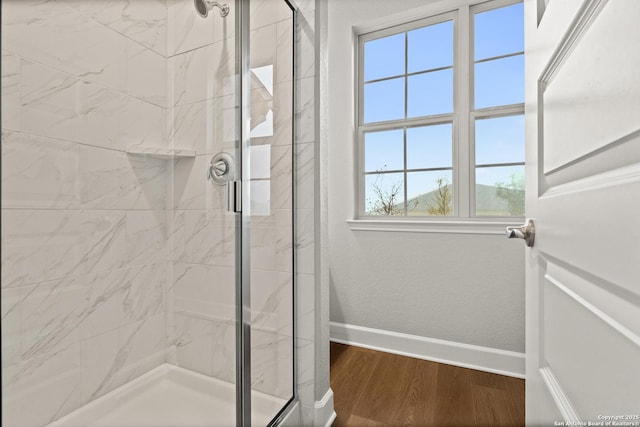 bathroom featuring hardwood / wood-style floors and walk in shower