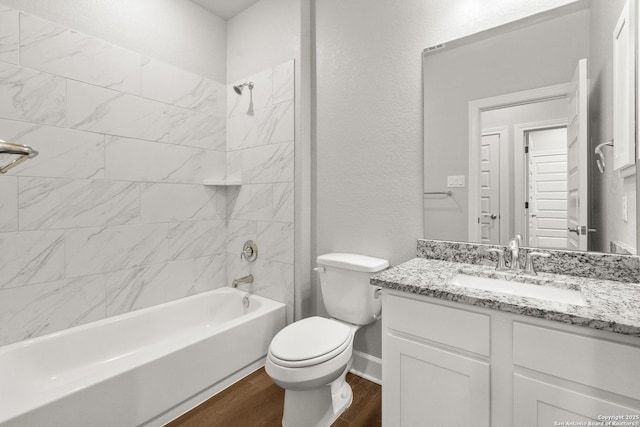 full bathroom featuring vanity, hardwood / wood-style floors, toilet, and tiled shower / bath