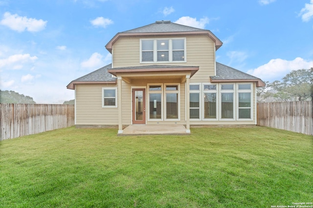 rear view of property featuring a patio and a lawn