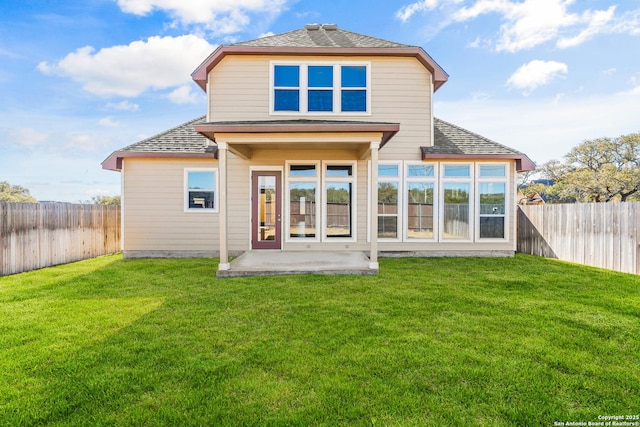 rear view of property with a lawn and a patio area