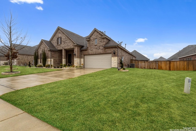 view of front of property featuring a garage, a front yard, and central air condition unit