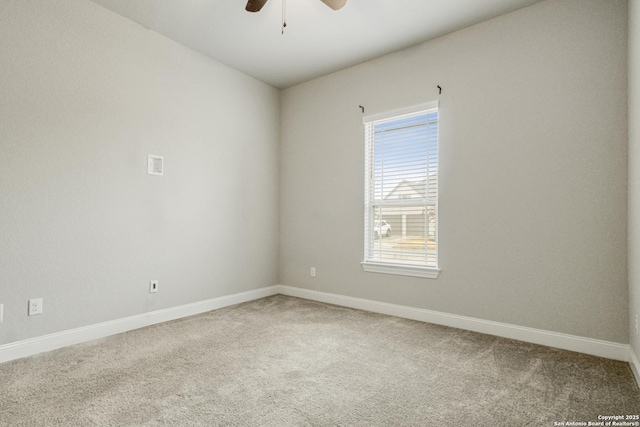 spare room with ceiling fan and carpet