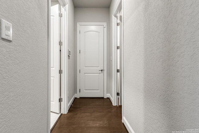 corridor with dark wood-type flooring