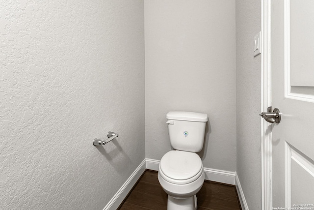 bathroom with hardwood / wood-style floors and toilet