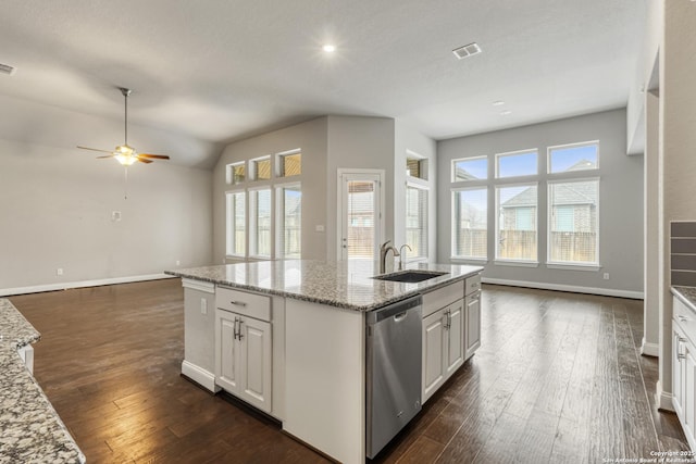 kitchen featuring white cabinetry, dishwasher, sink, an island with sink, and light stone countertops