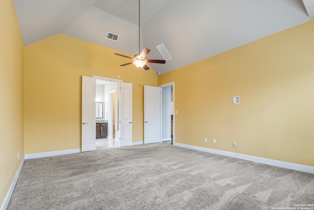 unfurnished bedroom with ceiling fan, carpet flooring, high vaulted ceiling, and ensuite bath