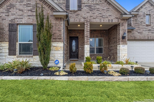 entrance to property with a garage and a yard