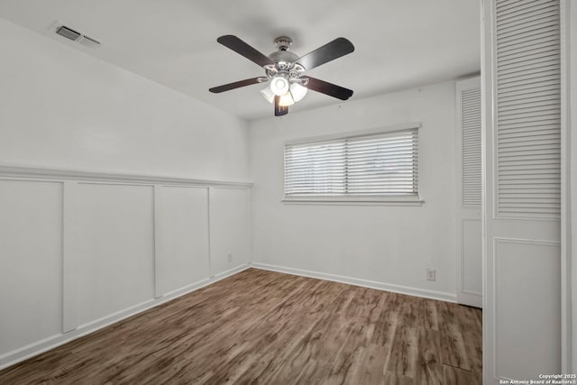 unfurnished bedroom featuring wood-type flooring, ceiling fan, and a closet