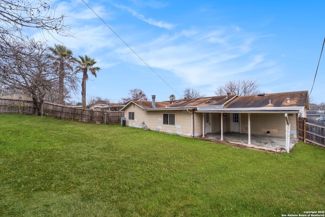 back of house featuring a yard and a patio