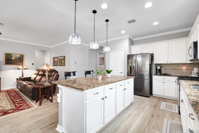 kitchen with light wood finished floors, stone countertops, and stainless steel appliances