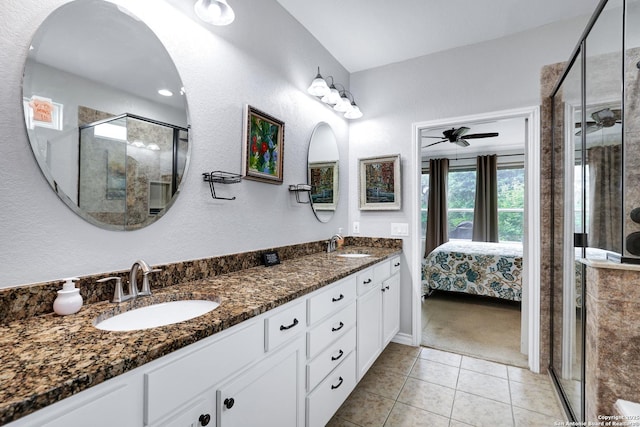 full bath featuring a stall shower, tile patterned flooring, a sink, and double vanity