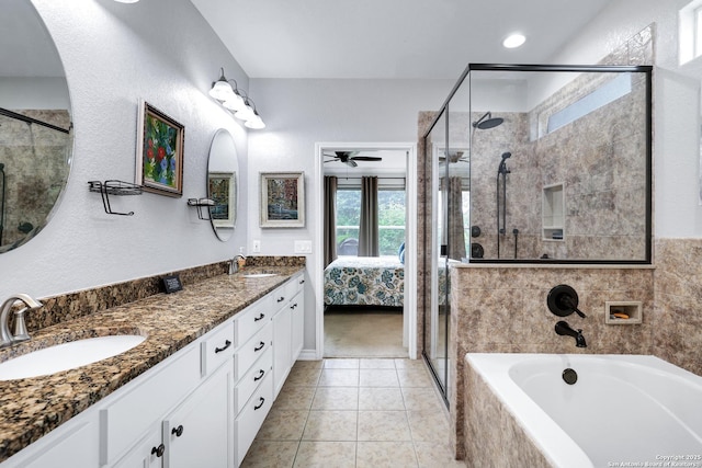 ensuite bathroom featuring double vanity, a stall shower, a sink, and a bath