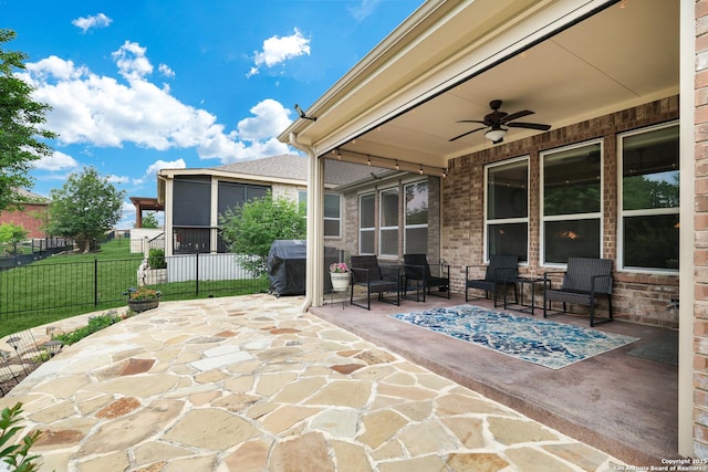 view of patio featuring a ceiling fan, a grill, and fence