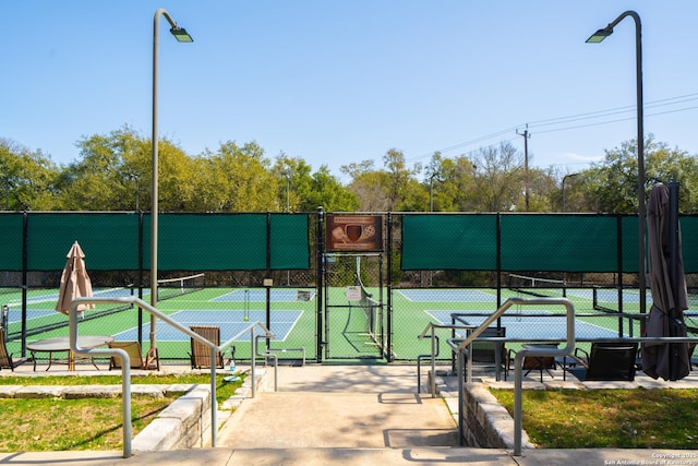 view of sport court featuring a gate and fence