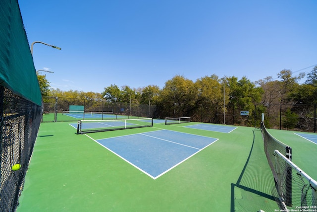 view of tennis court featuring fence