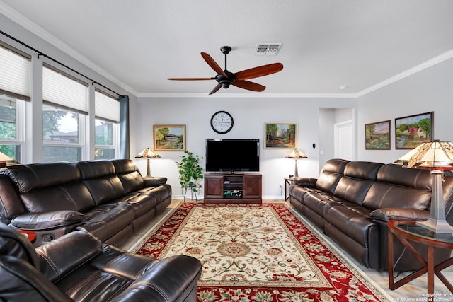 living area with visible vents, ornamental molding, ceiling fan, light wood-type flooring, and baseboards