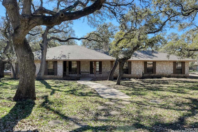 ranch-style house featuring a porch and a front lawn