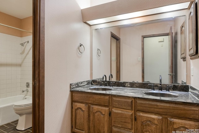 full bathroom with vanity, toilet, and tiled shower / bath