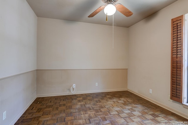 unfurnished room featuring dark parquet flooring and ceiling fan