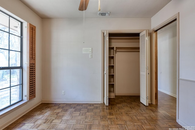 unfurnished bedroom with parquet floors and ceiling fan