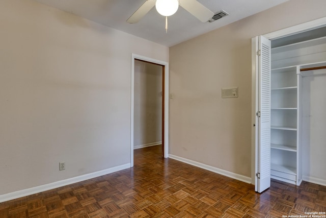 unfurnished bedroom with dark parquet flooring and ceiling fan