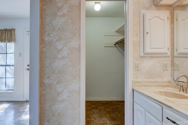 bathroom featuring vanity and parquet flooring