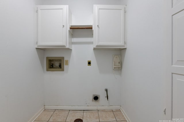 laundry room featuring cabinets, hookup for a gas dryer, washer hookup, light tile patterned floors, and hookup for an electric dryer