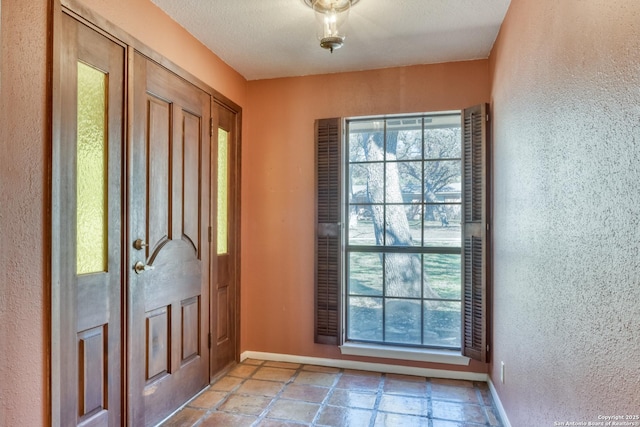 foyer entrance with a wealth of natural light and a textured ceiling