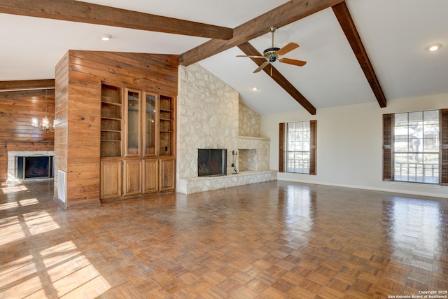 unfurnished living room with parquet floors, a high end fireplace, wooden walls, and ceiling fan